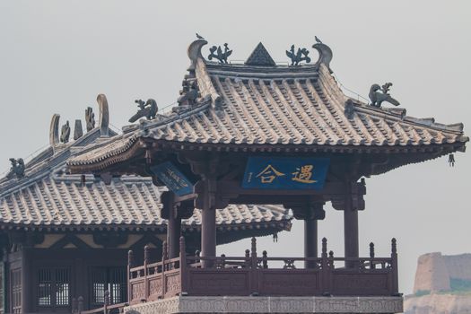 Close up of a Ming Dynasty look out tower with part of an original section of the Great Wall of Chinna in te background