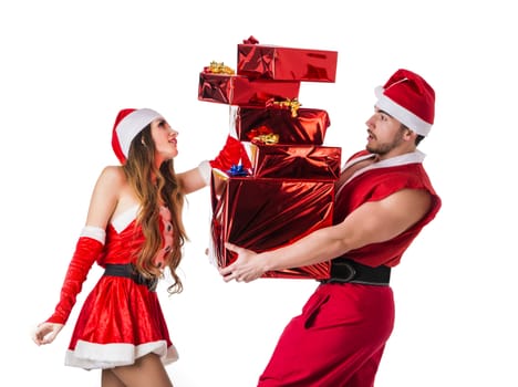 Handsome young man and pretty young woman in Santa Claus hat standing holding colorful festive Christmas gifts to celebrate the season, on white background