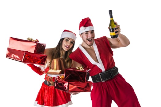 Handsome young man and pretty young woman in Santa Claus hat standing holding colorful festive Christmas gifts to celebrate the season, on white background