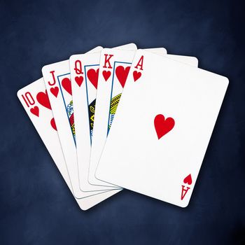 A royal straight flush playing cards poker hand in hearts