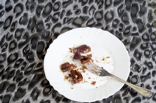 Top view of leftover chocolate cake, on spotted background