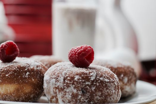 Delicious doughnuts on the white plate. Sweet fresh food concept.