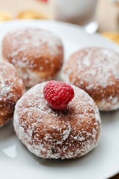 Delicious doughnuts on the white plate. Sweet fresh food concept.