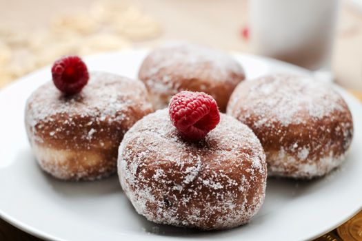 Delicious doughnuts on the white plate. Sweet fresh food concept.