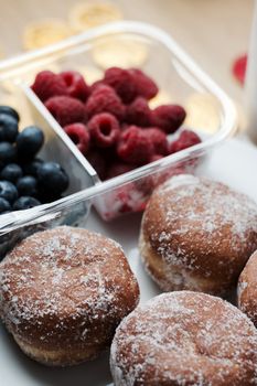 Delicious doughnuts on the white plate. Sweet fresh food concept.