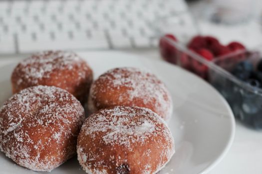 Delicious doughnuts on the white plate. Sweet fresh food concept.