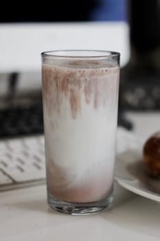 Fresh and delicious chocolate milk in glass. Office food concept.