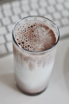 Fresh and delicious chocolate milk in glass. Office food concept.