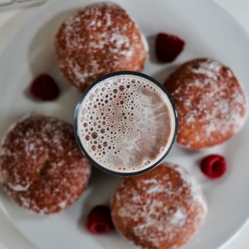 Delicious doughnuts on the white plate. Sweet fresh food concept.