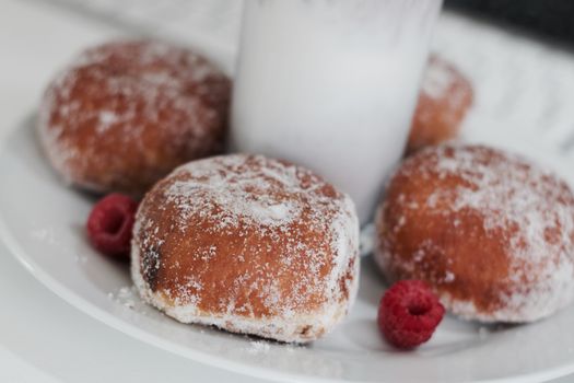 Delicious doughnuts on the white plate. Sweet fresh food concept.