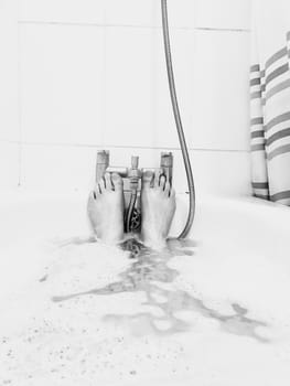 Two legs under water in the bath. Abstract hygiene concept.