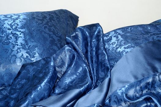morning sleeper bed, close up, whit elegant satin blue sheets