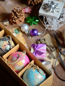 Gifts and vintage christmas ornaments on wooden table