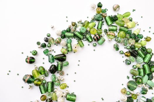 collection of green glass beads shaped into off center garland