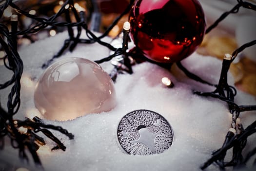 Digital currency physical metal bitcoin coin. Crypto currency christmas snow composition.