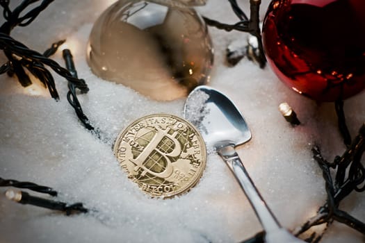 Digital currency physical metal bitcoin coin. Crypto currency christmas snow composition.