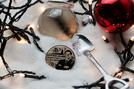 Digital currency physical metal bitcoin coin. Crypto currency christmas snow composition.