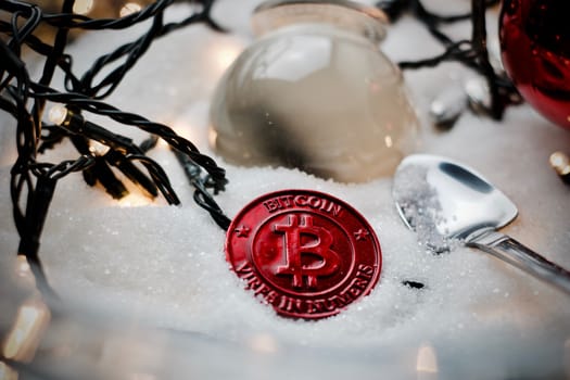 Digital currency physical metal bitcoin coin. Crypto currency christmas snow composition.