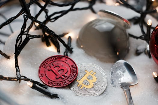 Digital currency physical metal bitcoin coin. Crypto currency christmas snow composition.