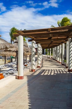 Caribbean style architectural walkway under a sunny sky