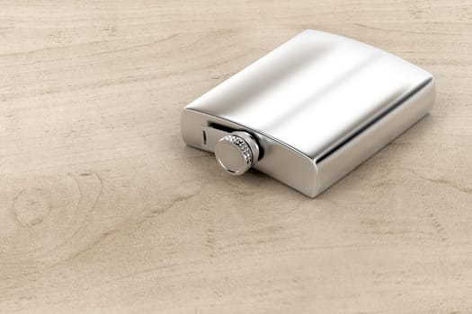 Silver hip flask on wood table