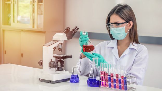 Portrait of Asian scientific researcher working in laboratory