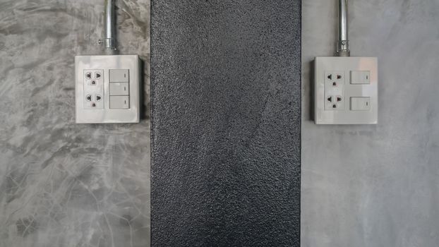 electric plug and switch on gray wall