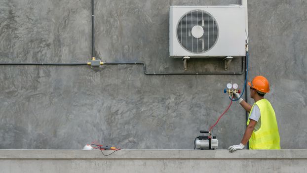 Technician is checking outdoor air conditioner unit