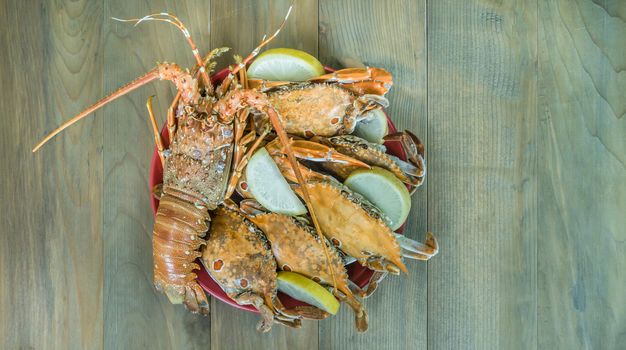 top view of steamed lobster and crab on plate