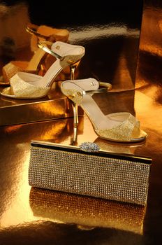 Golden clutch inlaid with rhinestone and a pair of gold shoes
