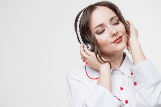 Beautiful girl in headphones listens to music. Slow motion.