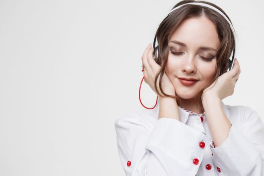 Beautiful girl in headphones listens to music. Slow motion.