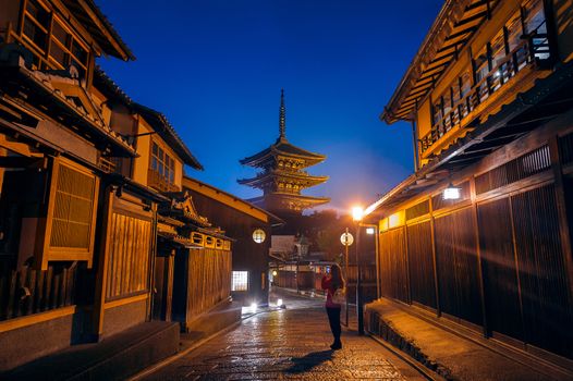 Woman take a photo at Yasaka Pagoda and Sannen Zaka Street in Kyoto, Japan.