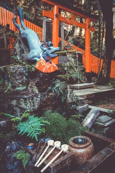 Fox purification fountain at Fushimi Inari Taisha torii shrine, Kyoto, Japan