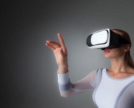 Young woman in white futuristic clothes with vr headset