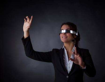 Business woman using futuristic VR goggles headset with microphone