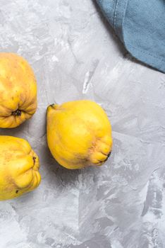 Ripe quince fruits on kitchen countertop.