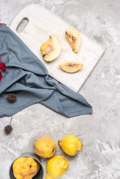 Quince fruit parts on concrete kitchen countertop.