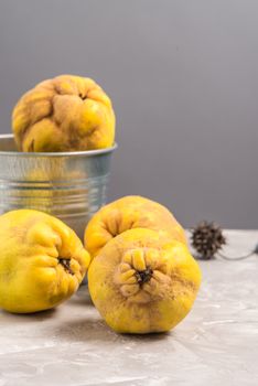 Ripe quince fruits on kitchen countertop.