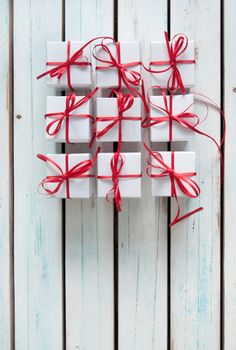 White gift boxes tied with red ribbon with background space