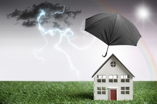 Umbrella protecting a house from bad weather