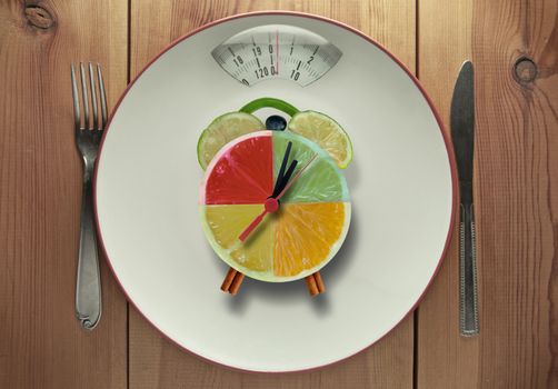 Plate with bathroom scales a clock made of fruit