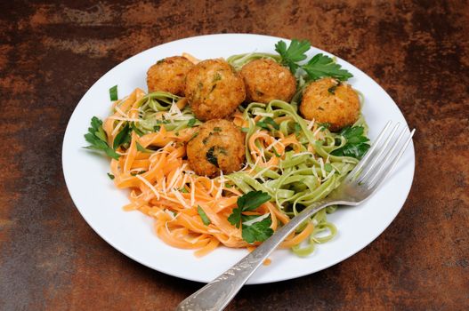 Spaghetti from carrots and spinach with chicken meatballs flavored cheese parmesan, herb