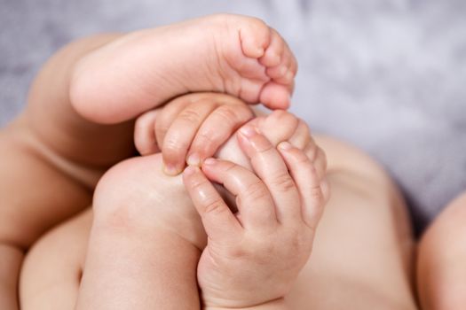 Close up of baby hands and feet of a newborn baby.