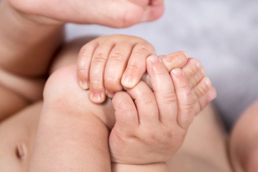 Close up of baby hands and feet of a newborn baby.