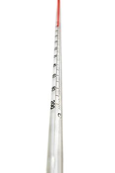 Close up view of a scientific long thermometer isolated on a white background.