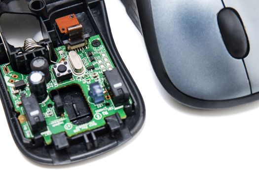 Computer Wheel mouse opened to see circuits inside isolated on a white background.