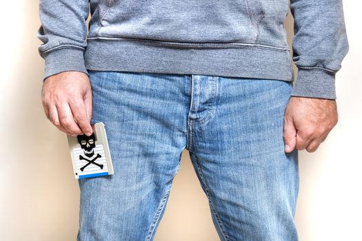 Man with infected floppy disk on pocket. Conceptual image with skull and bones.