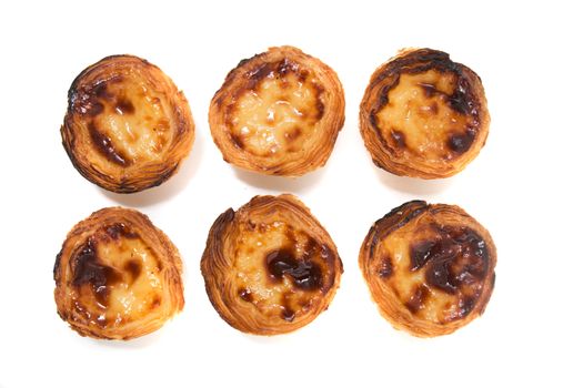 Famous Portuguese egg pastry tart called 'Pastel de Belem' isolated on white background.