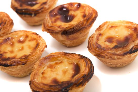 Famous Portuguese egg pastry tart called 'Pastel de Belem' isolated on white background.